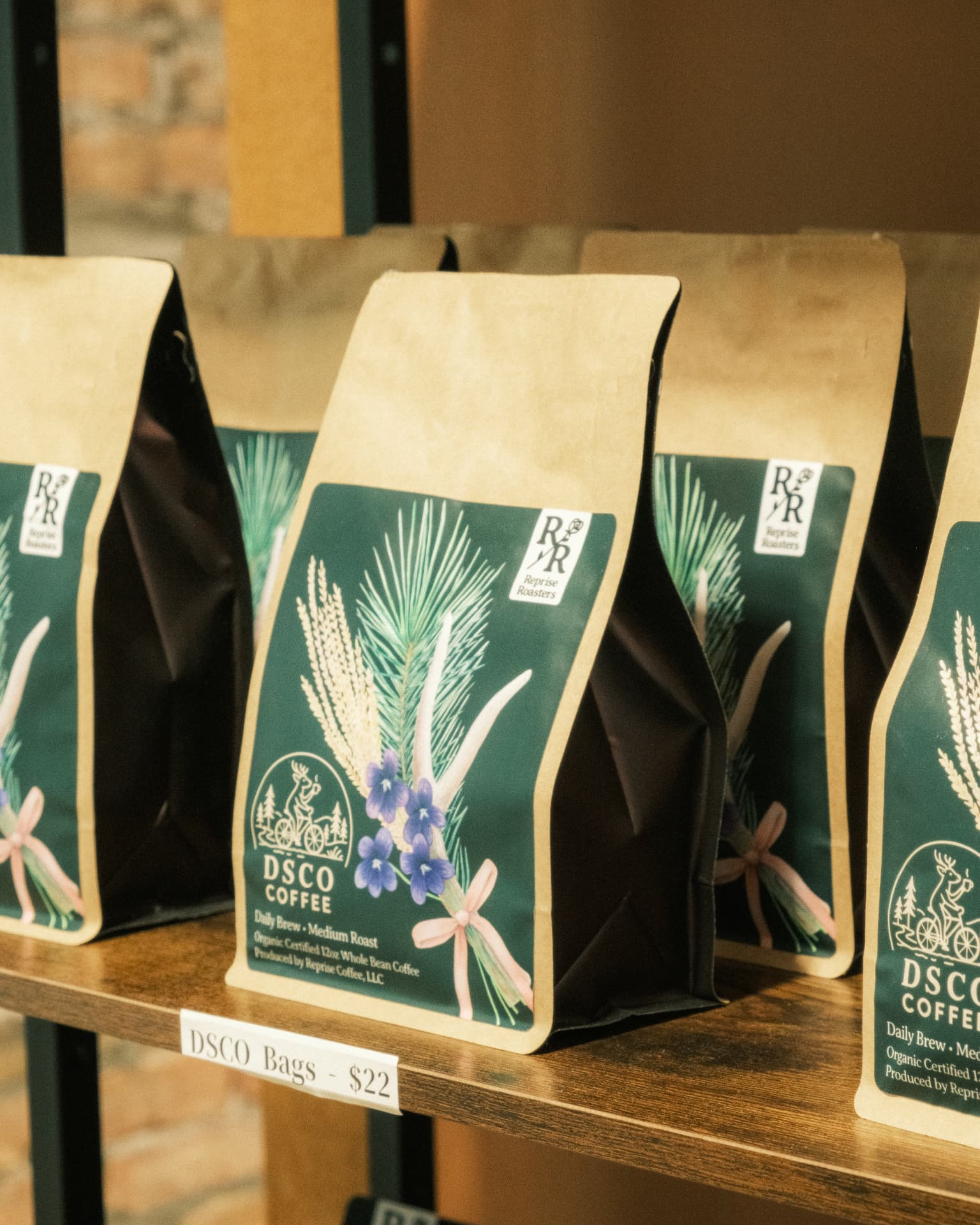 DSCO Coffee bags roasted by Reprise Roasters lined up on a wooden shelf