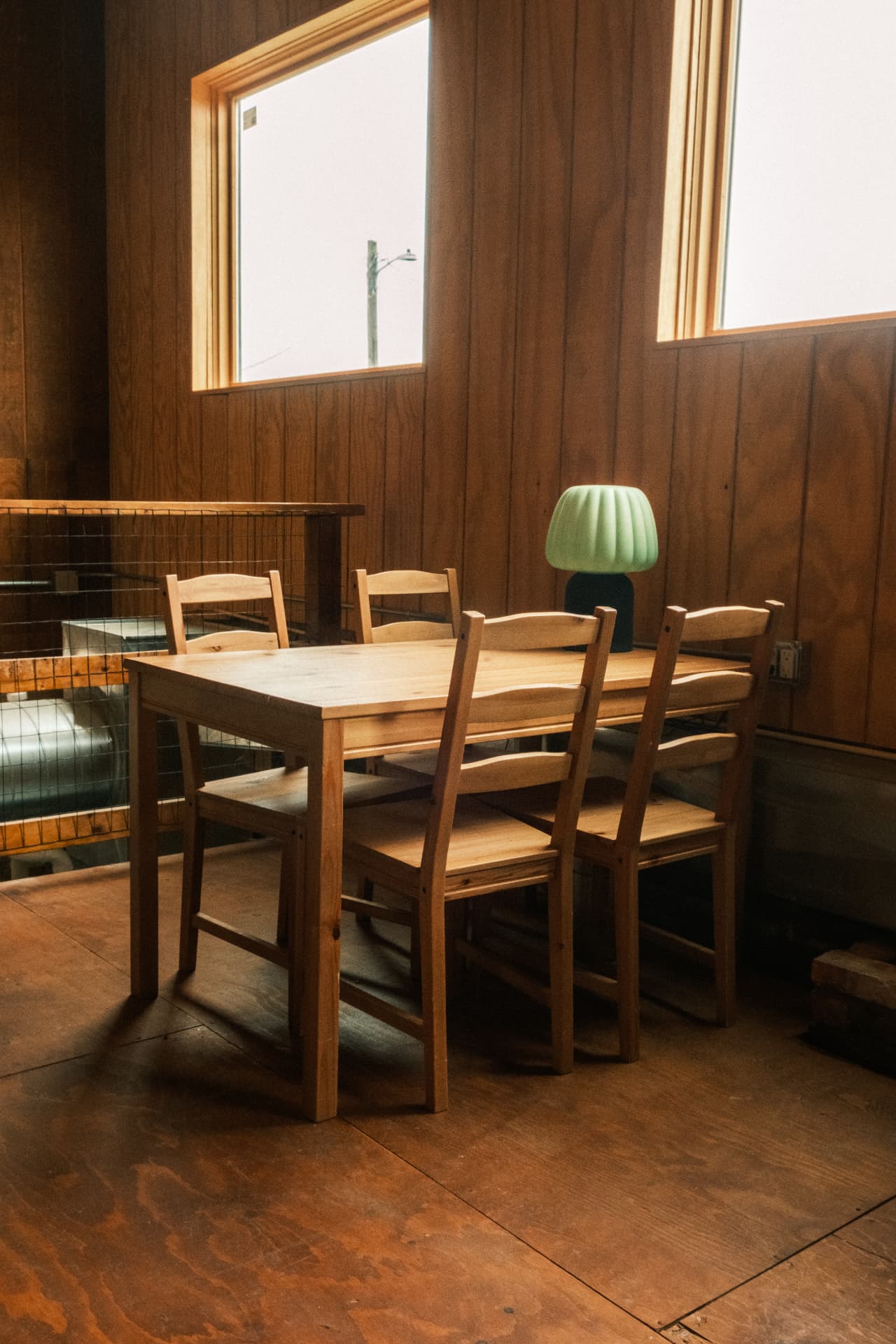 A wooden table and chairs in the upstairs seating area at DSCO Coffee